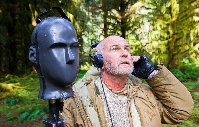 man in forest recording sounds